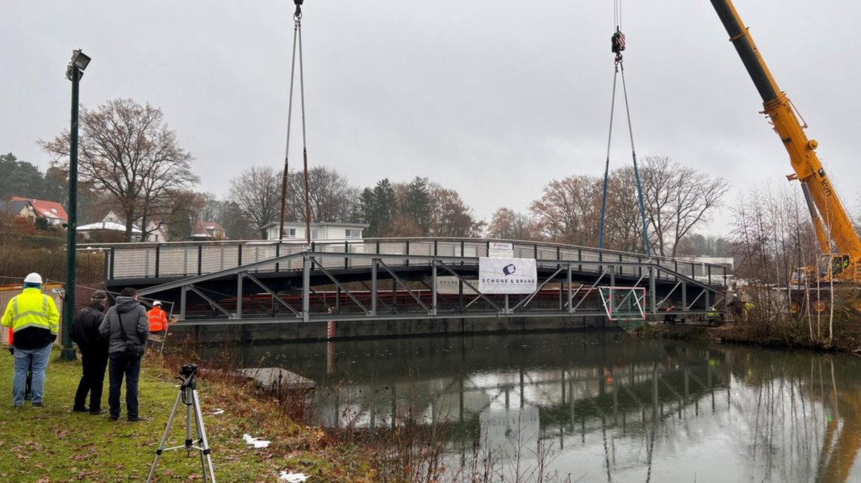 Die 34 Meter lange und circa drei Meter breite neue Brücke wurde erfolgreich über das Hafenbecken am Wassersportzentrum eingehoben.